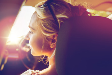 Fototapeta premium happy teenage girl or young woman in car