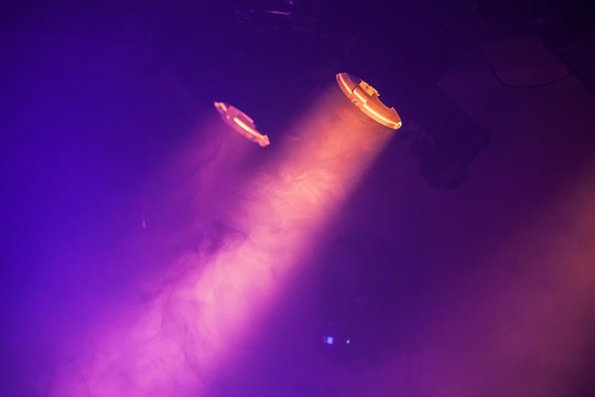 Spot lights with purple rays in the dark