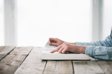 Woman reading and praying over Bible