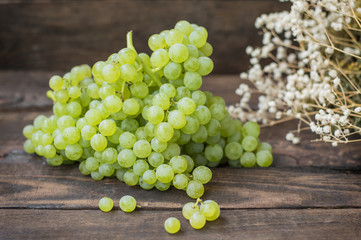 Sultan Grapes on a wooden background. Close-up. Selective focus