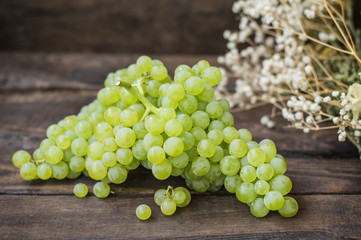 Sultan Grapes on a wooden background. Close-up. Selective focus