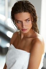 Fototapeta na wymiar Body Care. Beautiful Woman With Wet Hair In Towel After Bath