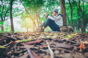 ASEAN traveler man with backpack  in forest