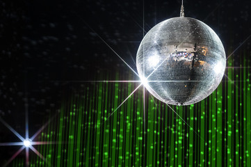 Disco ball with stars in nightclub with striped green and black walls lit by spotlight, party and...