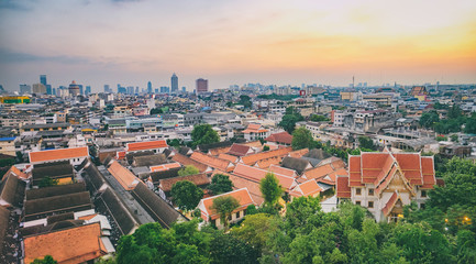 Fototapeta na wymiar Traditional architecture of Wat Saket from the height of bird flight. View of Bangkok from Golden Mountain during a colorful sunset, Thailand.
