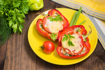 Stuffed bell peppers with rice and cheese. Wooden background. Close-up
