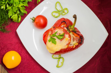 Stuffed bell peppers with rice and cheese. Wooden background. Top view. Close-up
