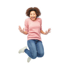 happy african american woman jumping over white