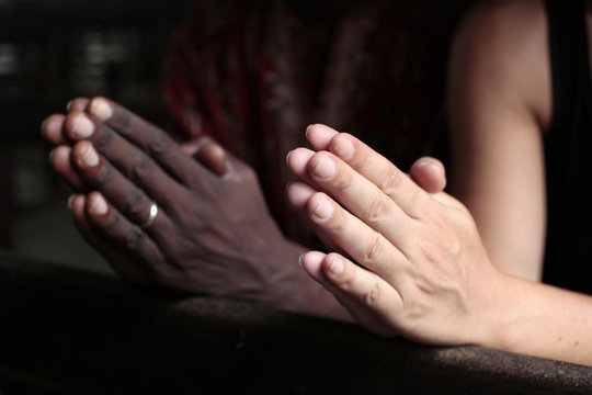 Man and woman praying together in a church, Cotonou, Benin, West Africa