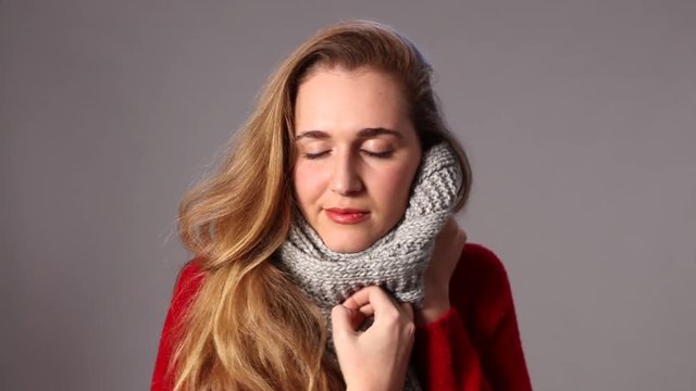 beautiful girl enjoying wearing winter woolen scarf for warm softness