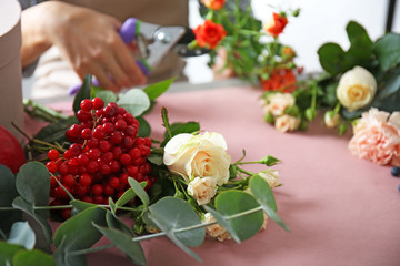 Beautiful flowers and berries on florists workplace