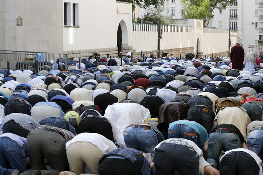 Muslims praying outside the Paris Great Mosque on Eid al-Fitr festival, Paris, France 