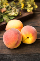 Ripe peaches on a wooden background. Close-up