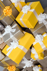 pile of yellow and grey Christmas gifts