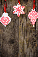 Gingerbread cookies hanging over wooden background