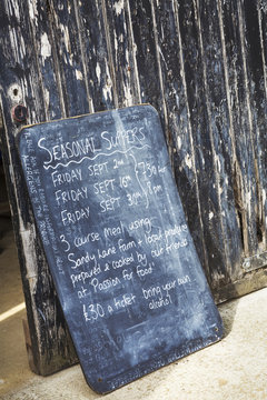 A menu board advertising seasonal suppers with details. 