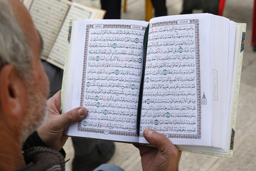 Palestinians reading the Koran outside Al-Aqsa mosque, Jerusalem, Israel
