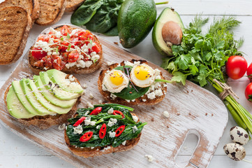 tasty and delicious bruschetta with with vegetables, cheese and micro greens
