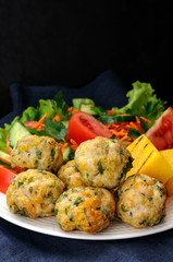 Polenta grill with chicken meatballs and fresh vegetables on a w