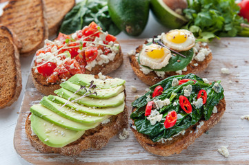 tasty and delicious bruschetta with with vegetables, cheese and micro greens