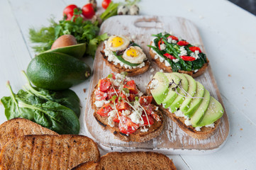 tasty and delicious bruschetta with with vegetables, cheese and micro greens