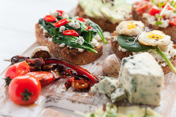 tasty and delicious bruschetta with with vegetables, cheese and micro greens