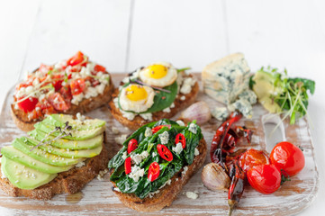 tasty and delicious bruschetta with with vegetables, cheese and micro greens