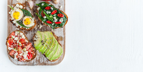 tasty and delicious bruschetta with with vegetables, cheese and micro greens