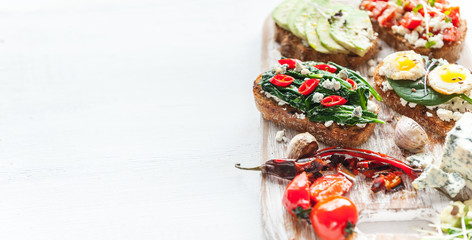 tasty and delicious bruschetta with with vegetables, cheese and micro greens