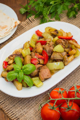 Vegetable stew with meat. Wooden background. Top view. Close-up