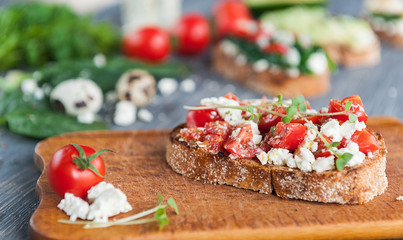 tasty and delicious bruschetta with with vegetables, cheese and micro greens