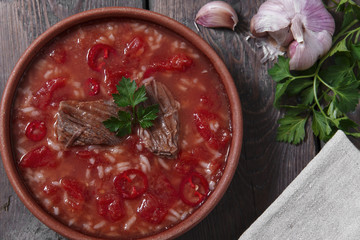 Traditional Georgian soup Kharcho with meat and rice in ceramic ware