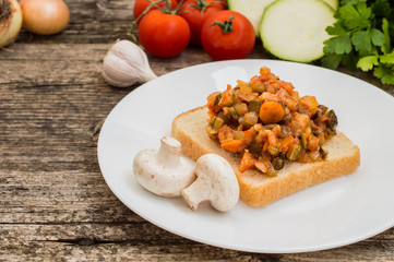 Squash caviar on toast. Wooden rustic background. Close-up