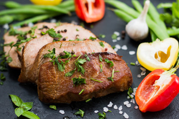 Very tasty cooked beef with spices and vegetables on old table