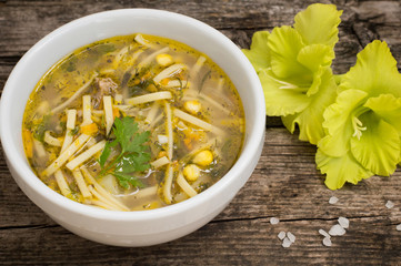 Chicken noodle soup and corn on the wooden table old. Top view. Close-up