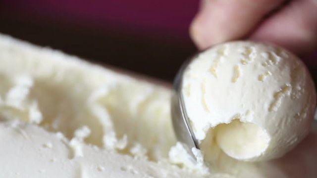 scooping vanilla ice cream ball close up