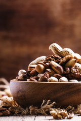 Nuts mix, healthy and beneficial food, vintage wooden background