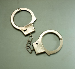 police handcuffs lying on a gray background
