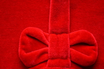 beautiful bright red velvet background with luxurious bow, cloth, fabric, wallpaper, texture, sewing