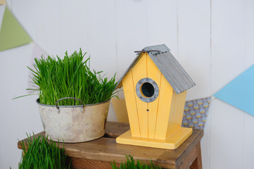 decorative birdhouse and green grass