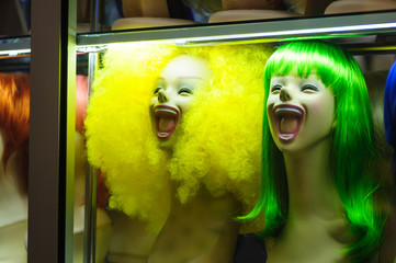 Mannequins in a shop window with colored hair