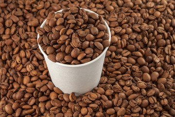 Coffee beans in a paper cup