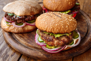 Classic american burgers, fast food on wood background