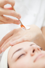 Facial mask.Beautiful young girl relaxing at spa ,getting skin treatment