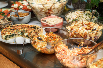 Bowls with various food in self service restaurant