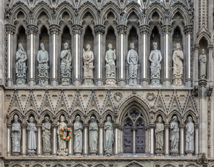 Fototapeta na wymiar Gothic West Front of Nidaros Cathedral in Trondheim Norway with the statue of Saint Olaf King of Norway decorated with a wreth