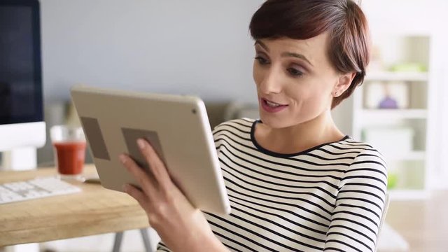 Business woman talking by digital tablet