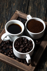 Obraz na płótnie Canvas Three types of coffee - ground, grain and beverage, vertical
