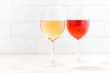 two glasses of wine on white wooden background