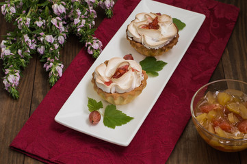Cake with meringue and pumpkin  apple jam on the background color. Wooden rustic table. Close-up